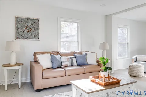 a living room with furniture potted plant and window