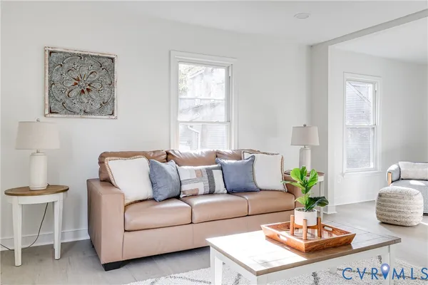 a living room with furniture potted plant and window