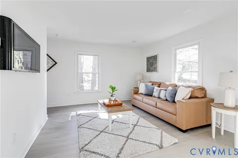 a living room with furniture a window and a table