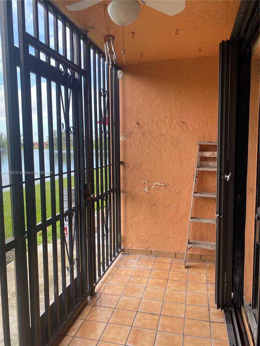 2460 West 67th Place, Unit 10127 Hialeah, FL 33016 - Photo 30 of 36 Screened Porch where you can enjoy your morning coffee or a wine in the afternoon.