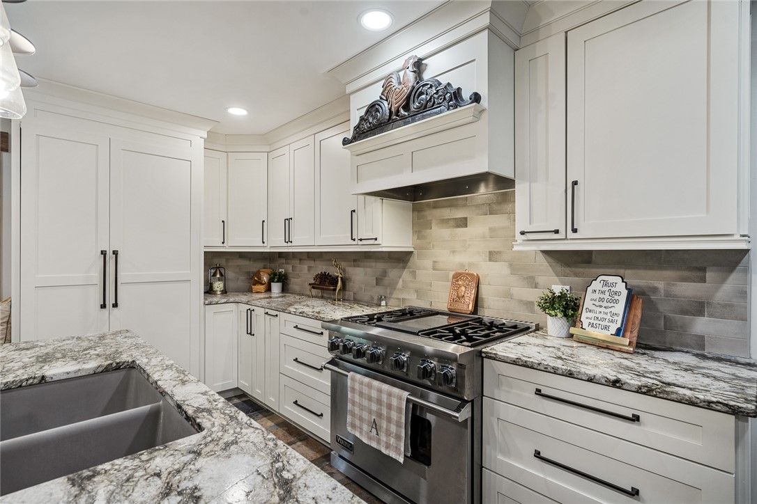 2817 Providence Church Road Anderson, SC 29626 - Photo 15 of 35 White cabinetry, mottled countertops, and stainless appliances create a bright and modern kitchen.