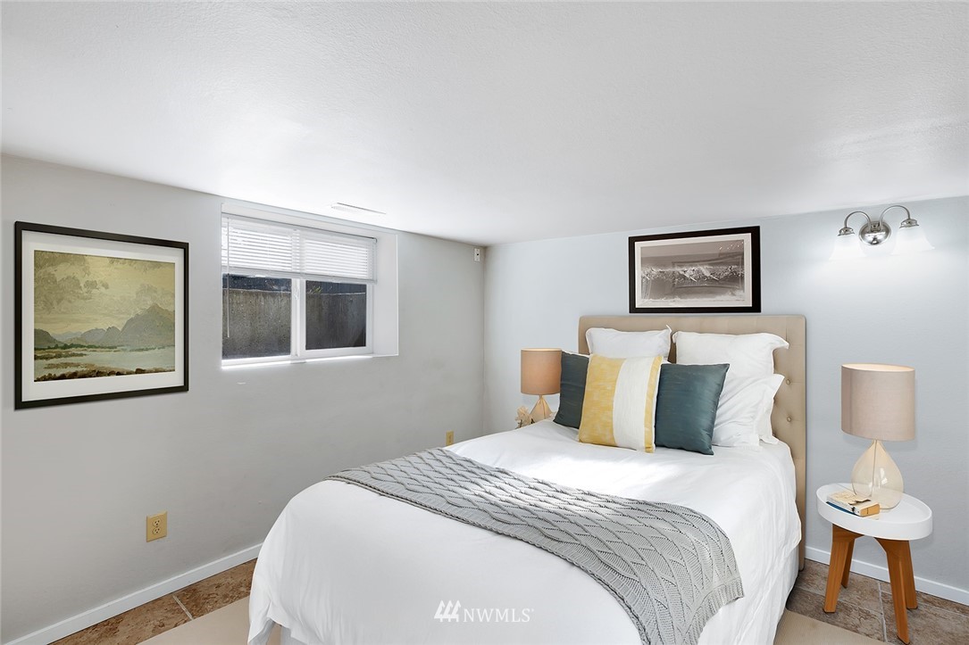 5300 Northeast 4th Street Renton, WA 98059 - Photo 9 of 12 a bedroom with a large bed and a lamp