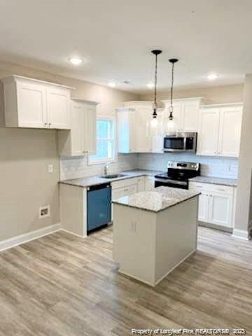 754 Walker (lot 1) Road Rockingham, NC 28379 - Photo 13 of 50 a kitchen with stainless steel appliances granite countertop a stove a sink and a refrigerator