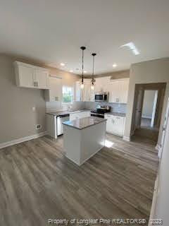 754 Walker (lot 1) Road Rockingham, NC 28379 - Photo 22 of 50 a large kitchen with stainless steel appliances kitchen island granite countertop a stove a sink dishwasher and a oven