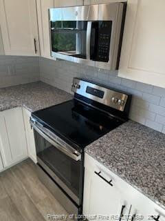 754 Walker (lot 1) Road Rockingham, NC 28379 - Photo 25 of 50 a close view of a stove a microwave and cabinets in the kitchen