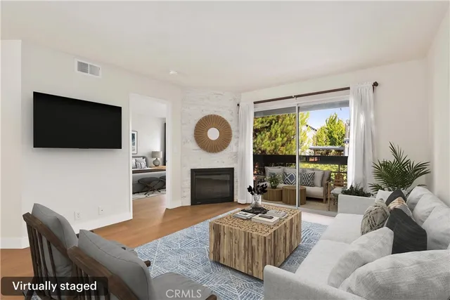 a living room with furniture a fireplace and a flat screen tv