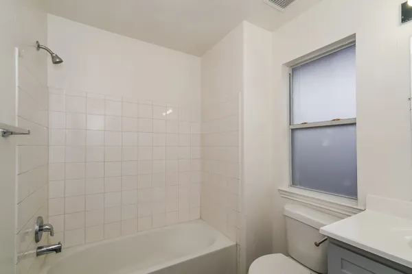 a bathroom with a bathtub and toilet