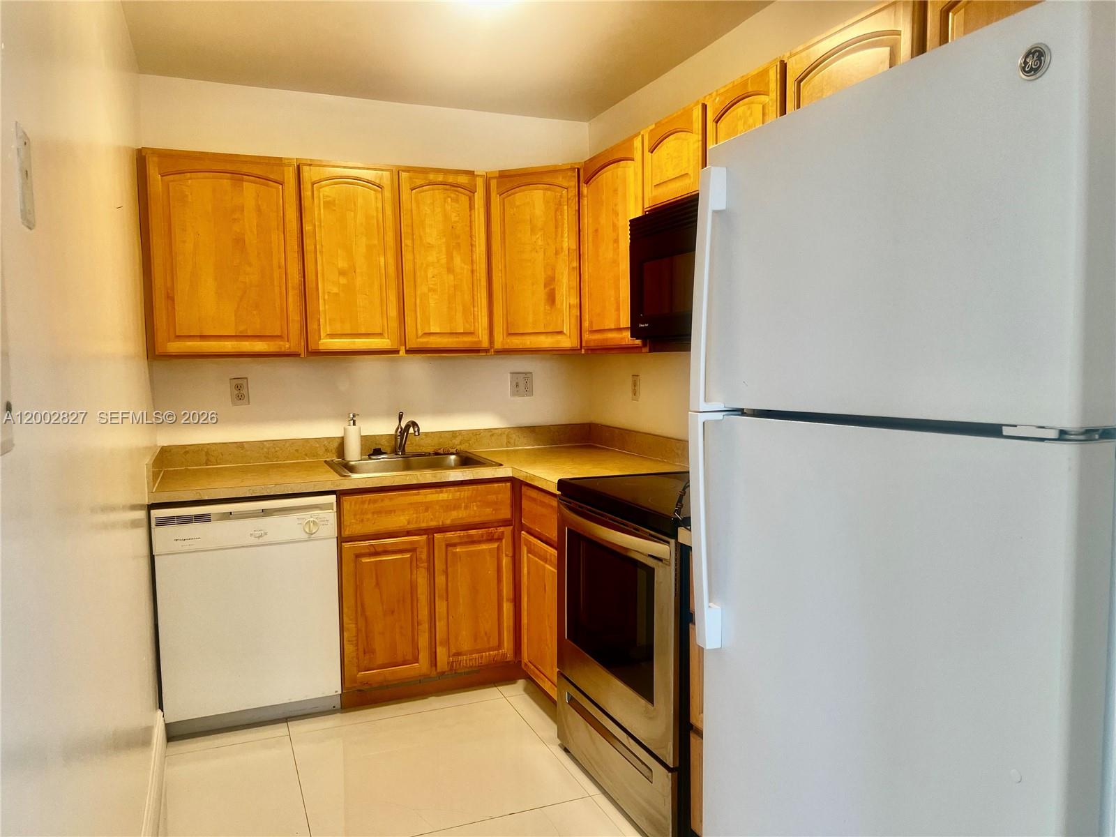 405 South Pine Island Road, Unit 403D Plantation, FL 33324 - Photo 11 of 14 a kitchen with stainless steel appliances granite countertop a refrigerator sink and stove