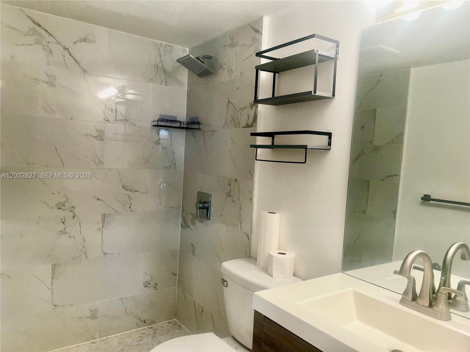 405 South Pine Island Road, Unit 403D Plantation, FL 33324 - Photo 8 of 14 a bathroom with a sink toilet and shower