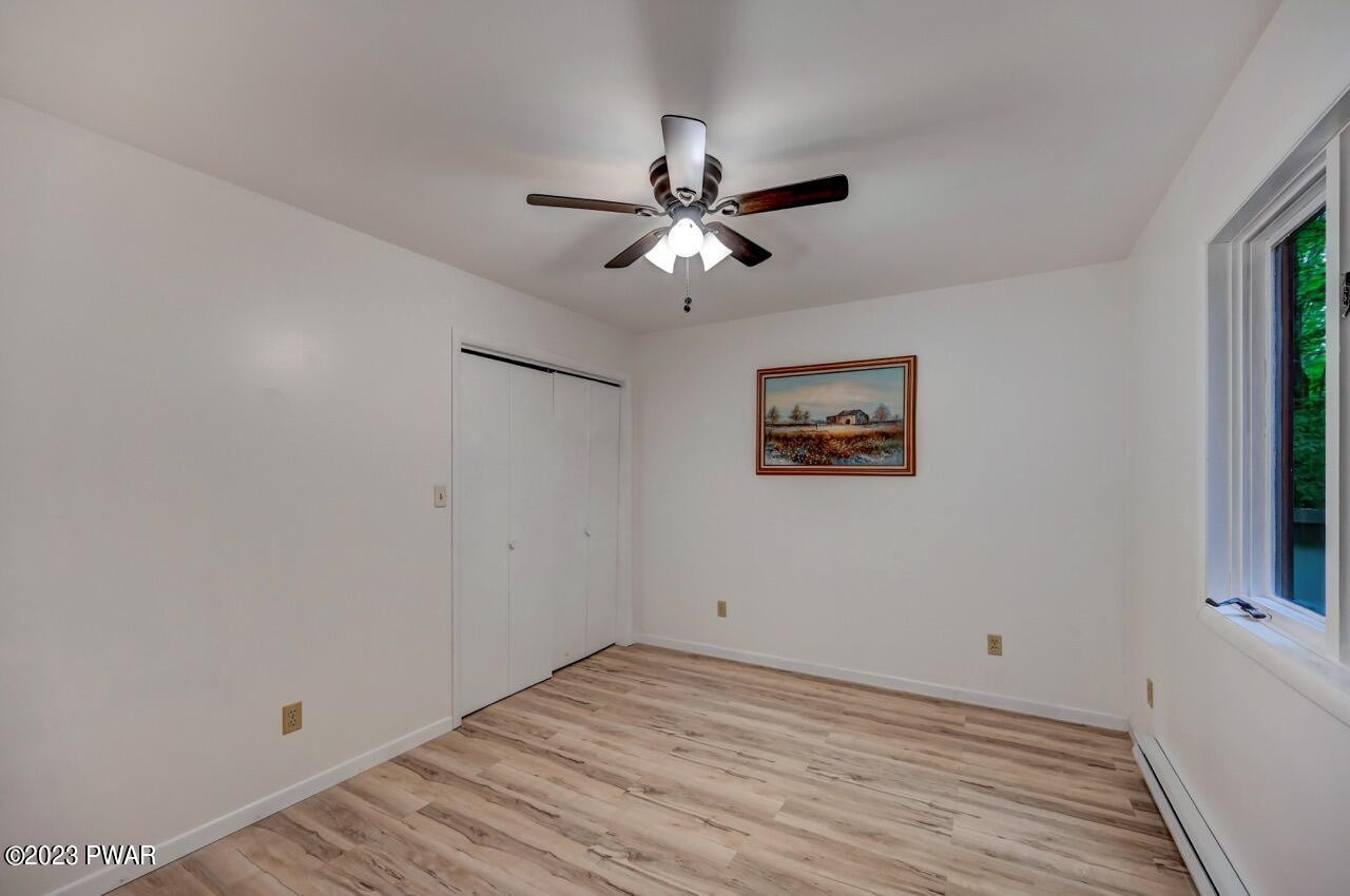 3238 Northgate Road Lake Ariel, PA 18436 - Photo 35 of 49 a view of a big room with wooden floor and a chandelier fan