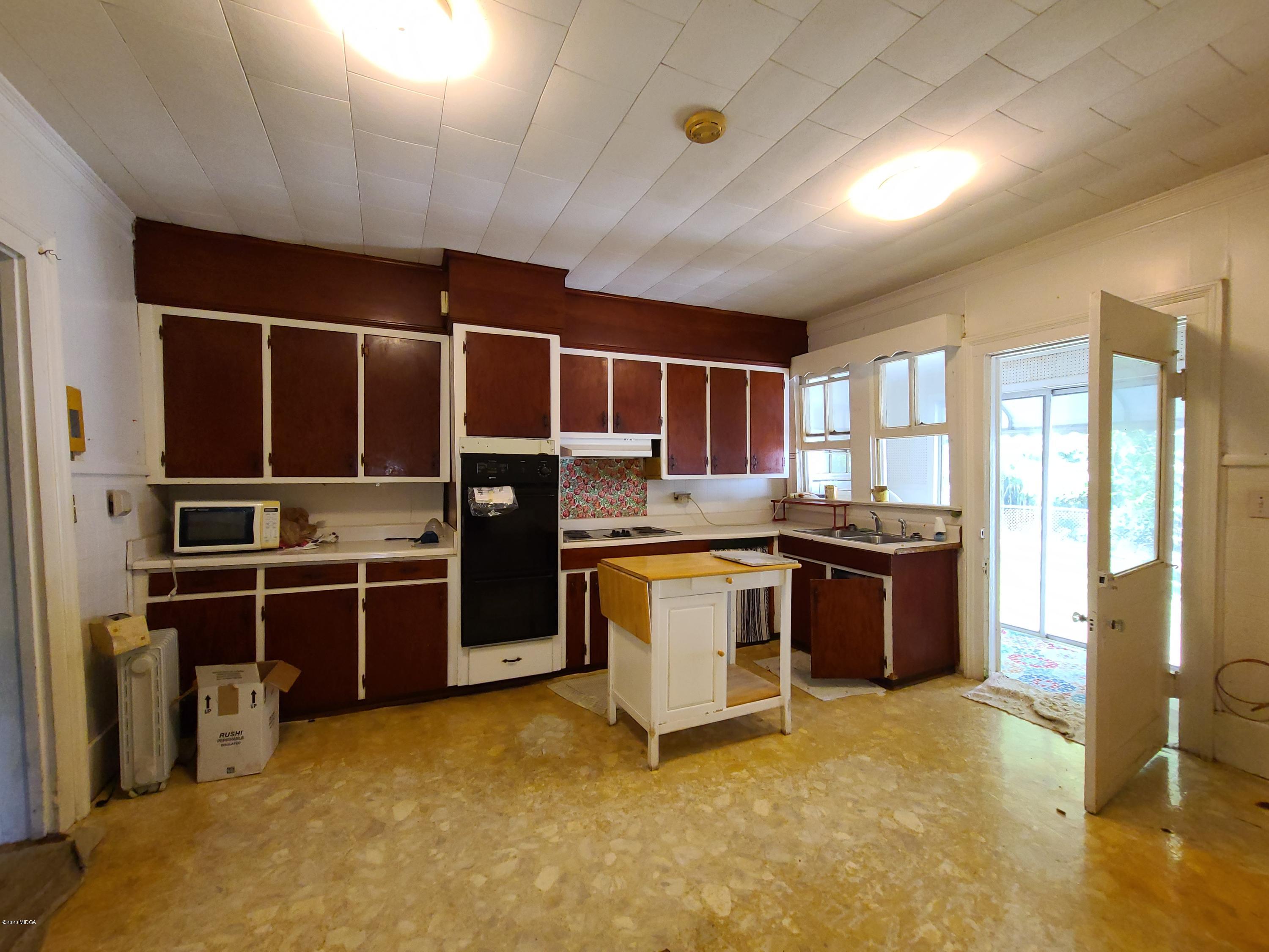 3824 Hartley Bridge Road Macon, GA 31216 - Photo 13 of 26 a kitchen with refrigerator cabinets and counter top space