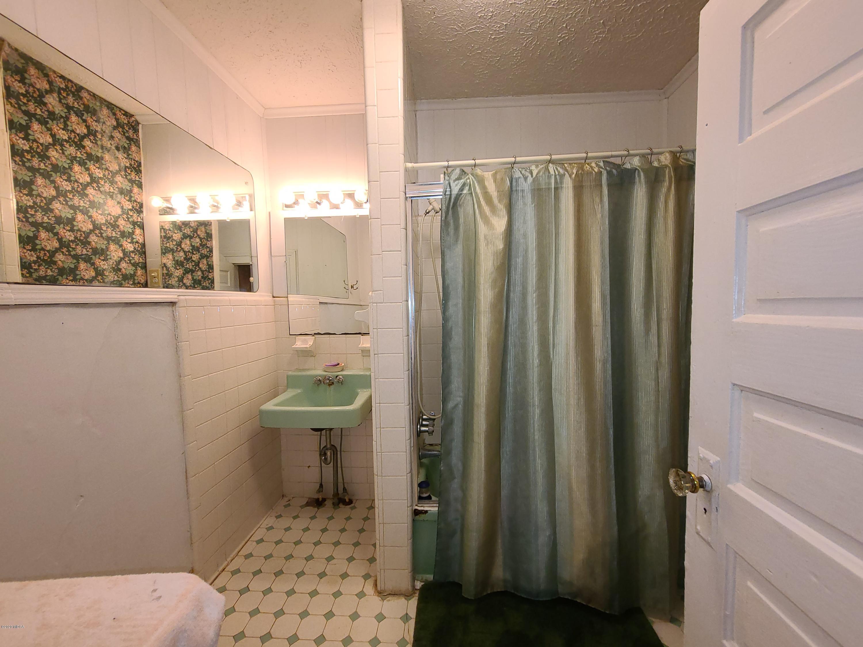 3824 Hartley Bridge Road Macon, GA 31216 - Photo 15 of 26 a bathroom with a sink a toilet and shower