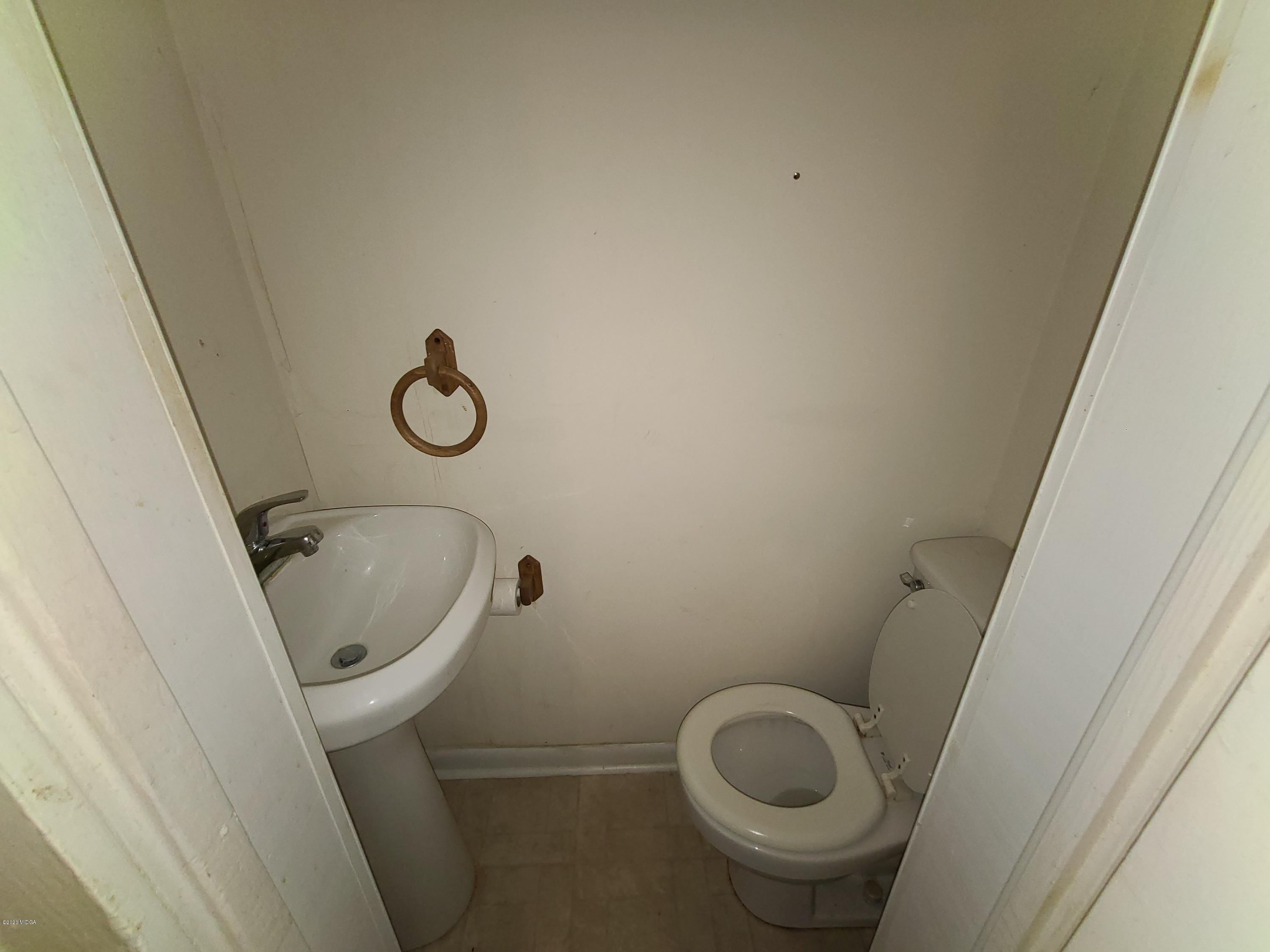 3824 Hartley Bridge Road Macon, GA 31216 - Photo 17 of 26 a bathroom with a toilet and a sink