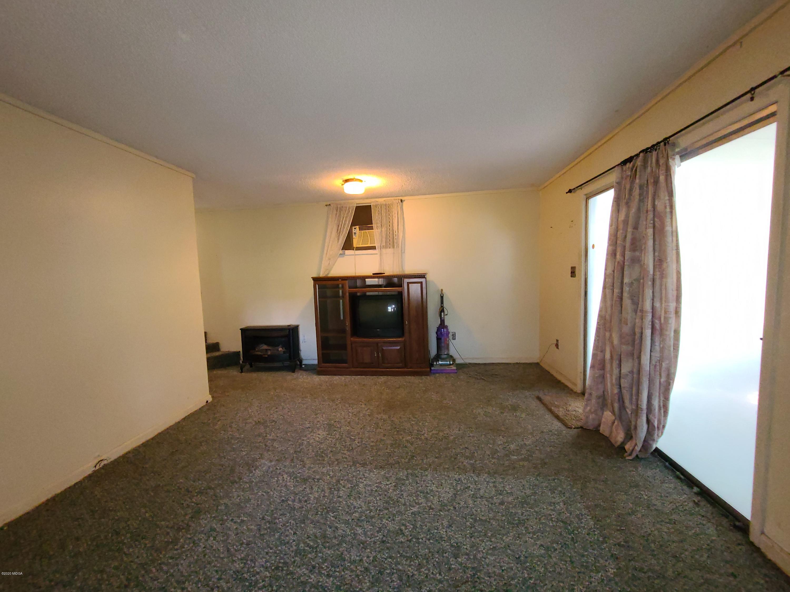 3824 Hartley Bridge Road Macon, GA 31216 - Photo 19 of 26 a view of empty room with fireplace and window