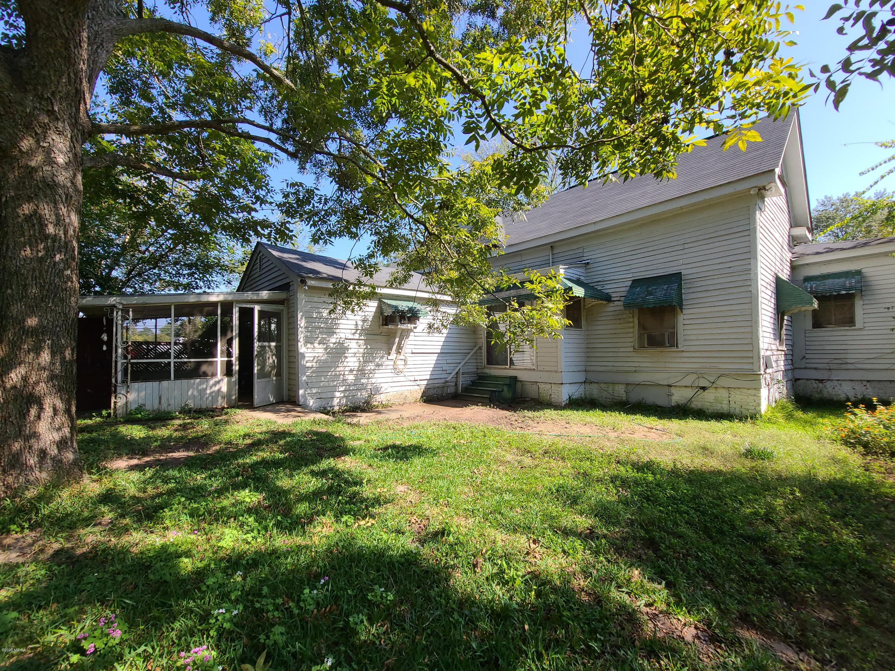 3824 Hartley Bridge Road Macon, GA 31216 - Photo 24 of 26 a front view of a house with a yard and garage