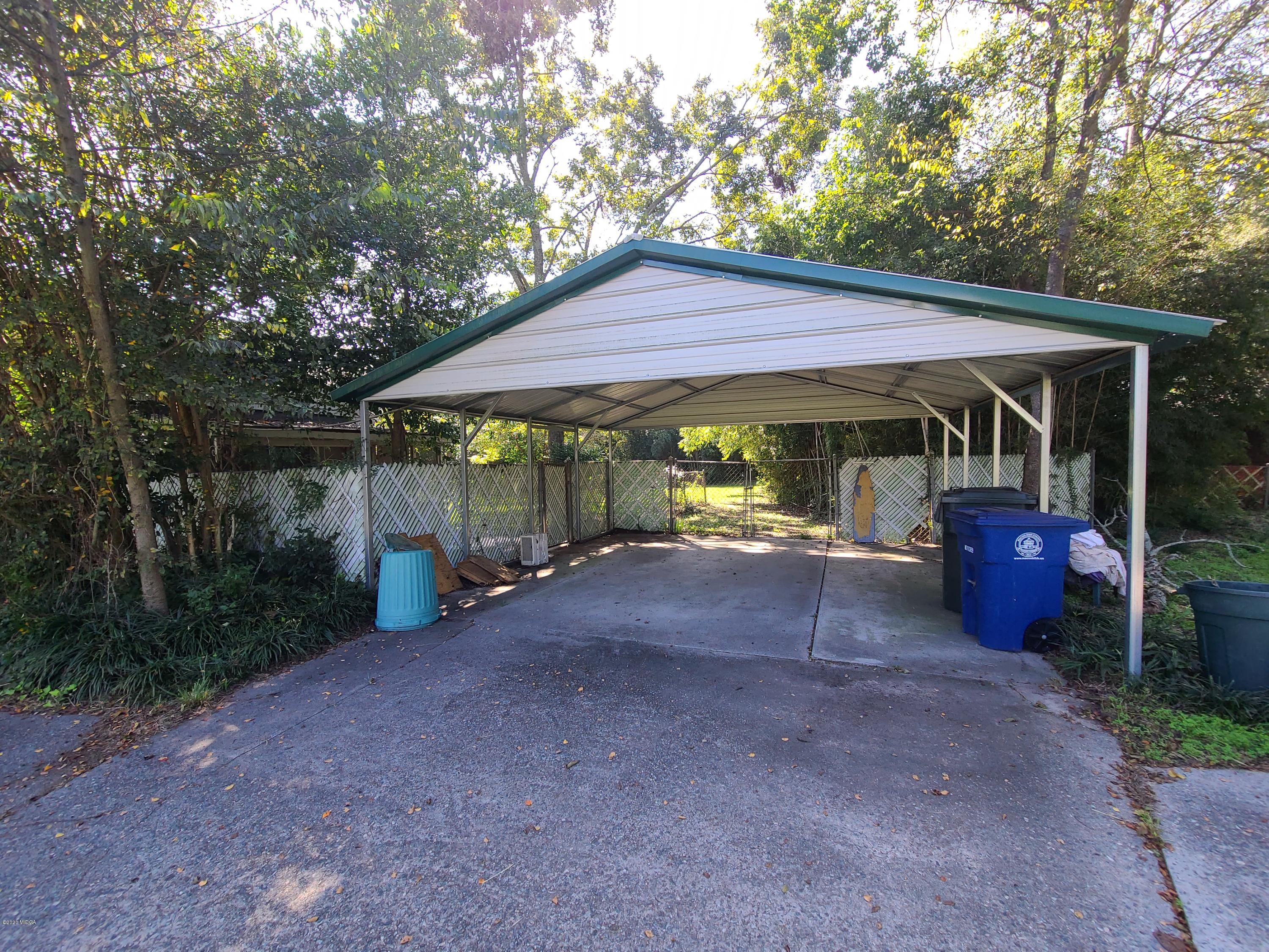 3824 Hartley Bridge Road Macon, GA 31216 - Photo 4 of 26 a view of a patio with a table and chairs under an umbrella