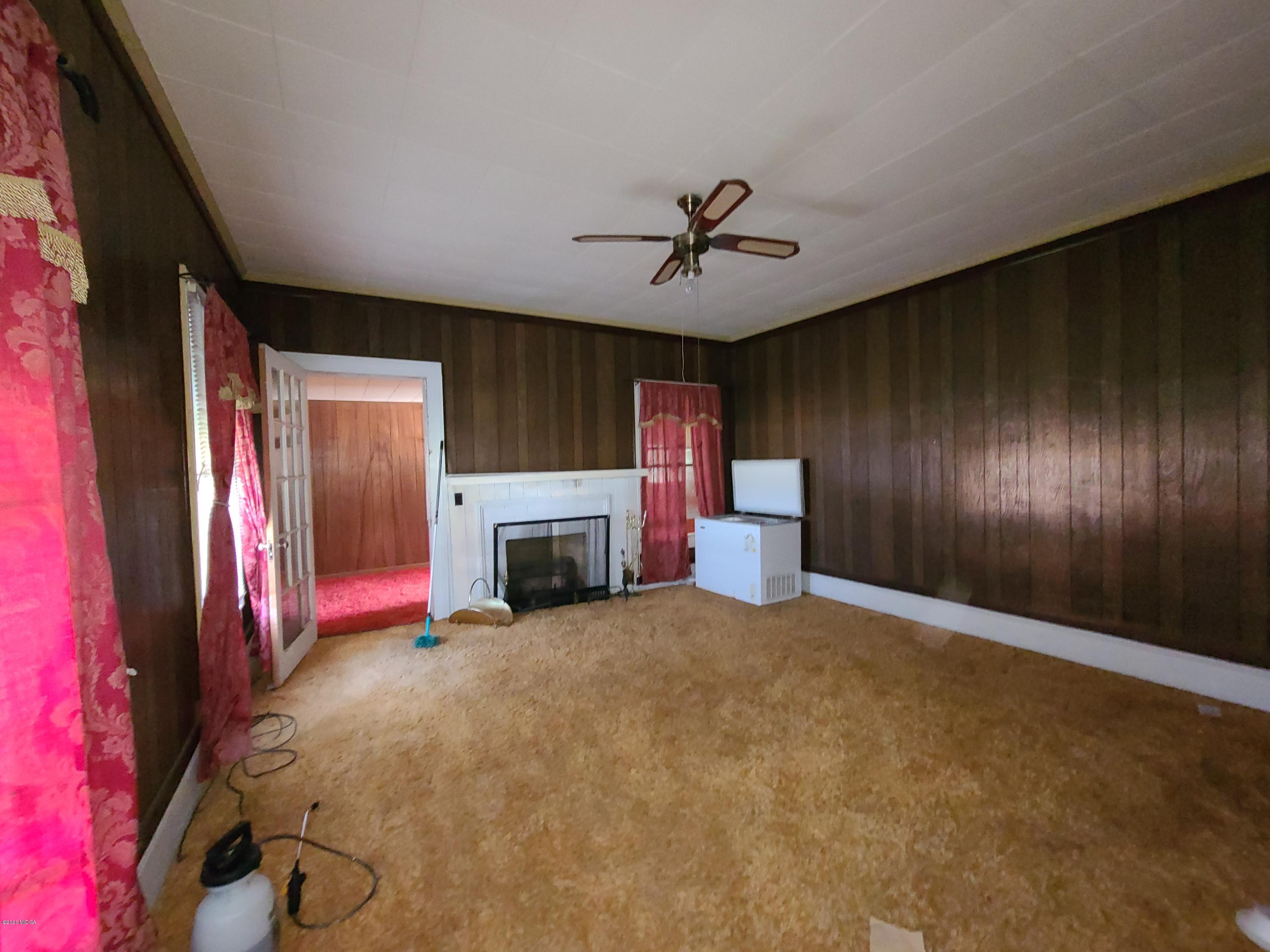 3824 Hartley Bridge Road Macon, GA 31216 - Photo 6 of 26 a view of an empty room with a fireplace
