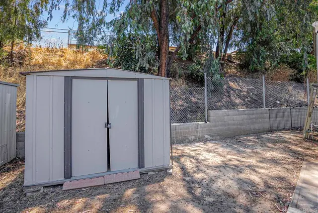 a view of a yard with wooden fence