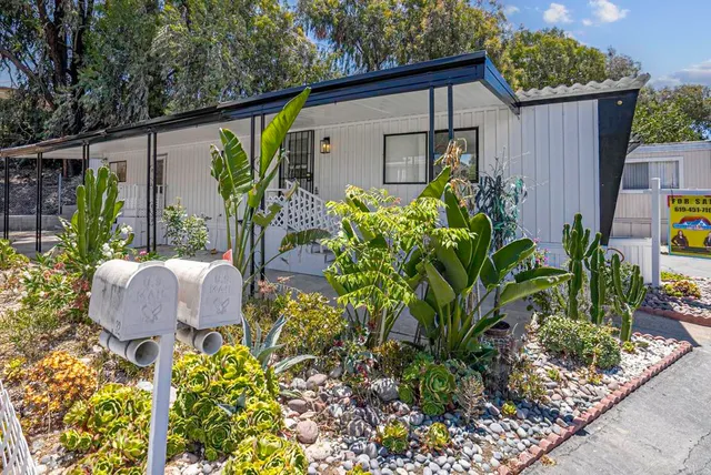 a view of a backyard with plants and a patio