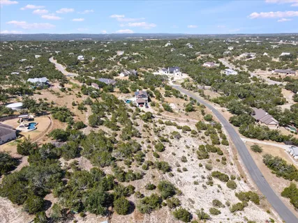 an aerial view of residential houses with city view