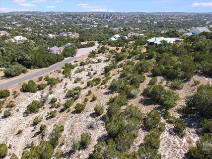 an aerial view of residential houses with city view