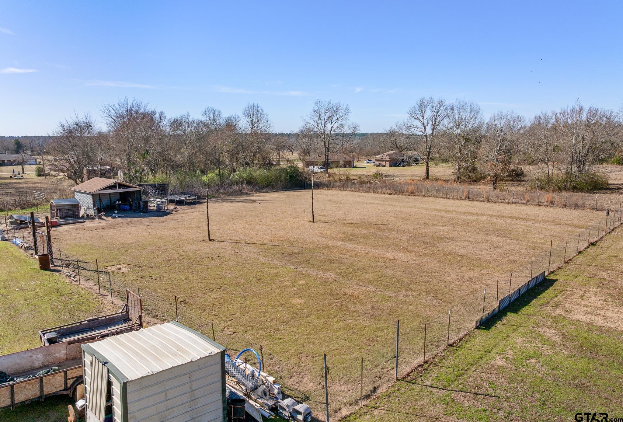 7573 County Road 48 Tyler, TX 75704 - Photo 27 of 31 a terrace with outdoor seating and trees in the background