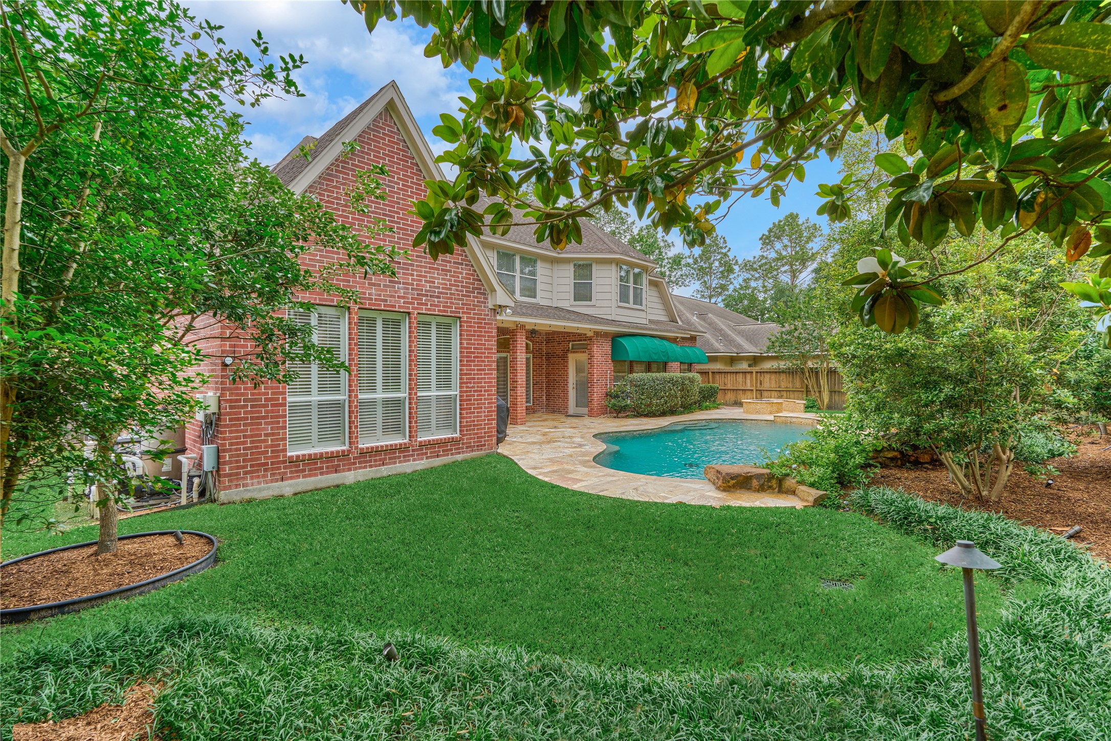 7 Gentry Oak Court Spring, TX 77381 - Photo 44 of 50 a front view of a house with a yard and trees