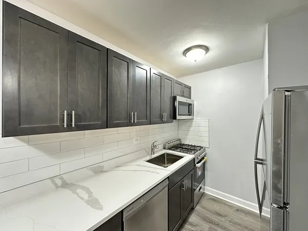 a kitchen with a sink and a refrigerator