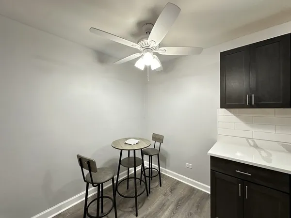 a view of a livingroom with furniture and chandelier fan