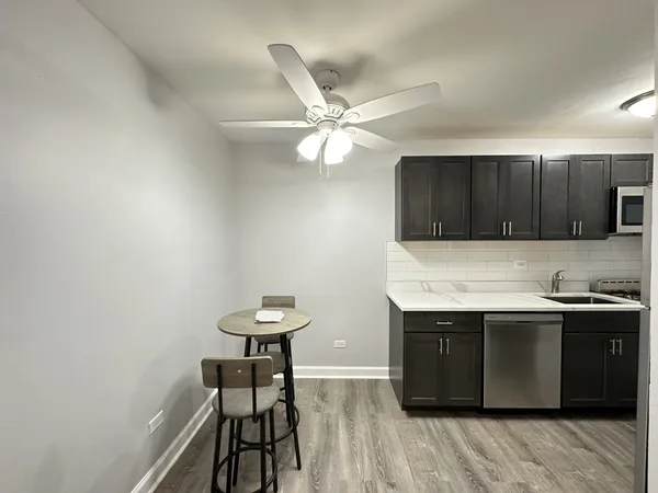 a kitchen with a sink cabinets and window