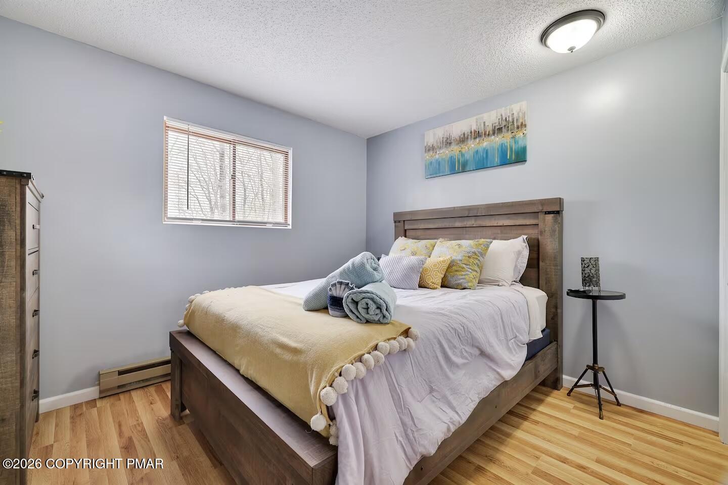 242 St Andrews Drive Bushkill, PA 18324 - Photo 20 of 36 a bedroom with a bed and wooden floor