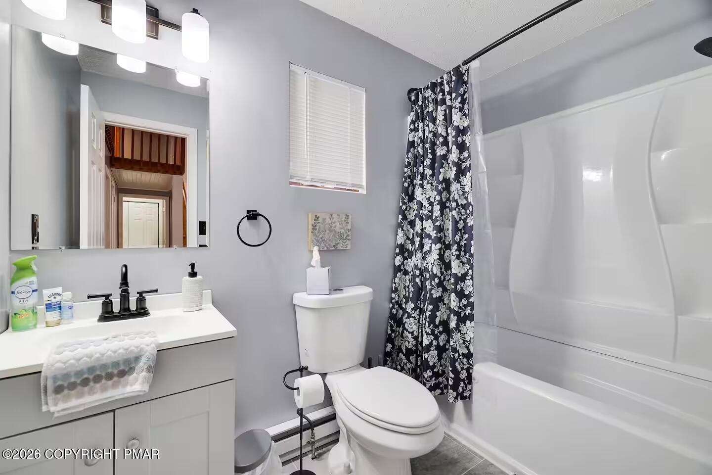 242 St Andrews Drive Bushkill, PA 18324 - Photo 21 of 36 a bathroom with a sink a toilet a window and a mirror