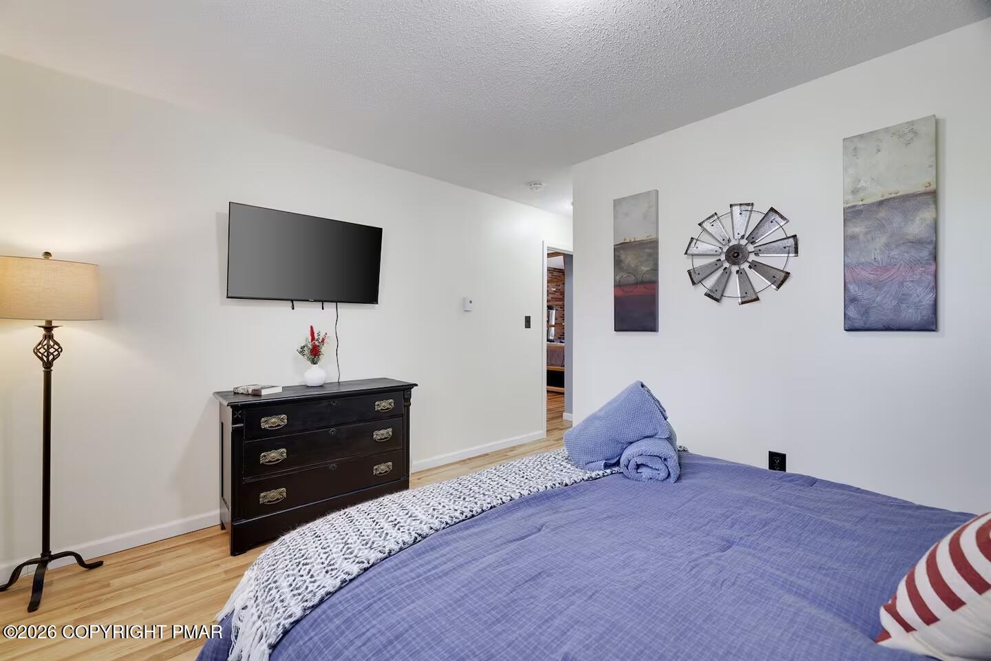 242 St Andrews Drive Bushkill, PA 18324 - Photo 22 of 36 a bedroom with a bed and a flat screen tv
