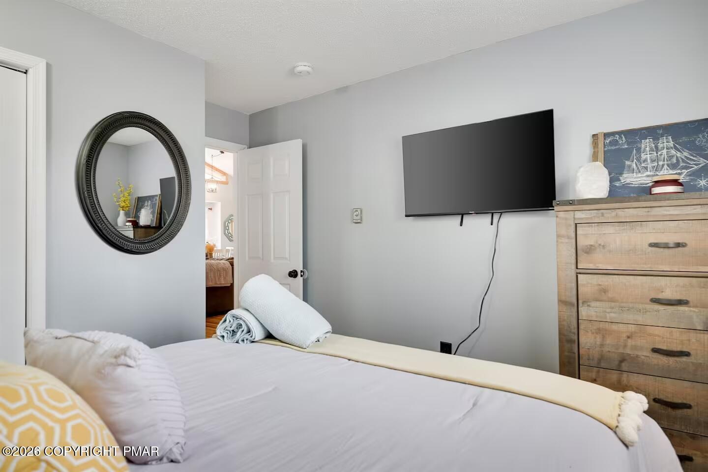 242 St Andrews Drive Bushkill, PA 18324 - Photo 23 of 36 a bedroom with a bed and a flat screen tv