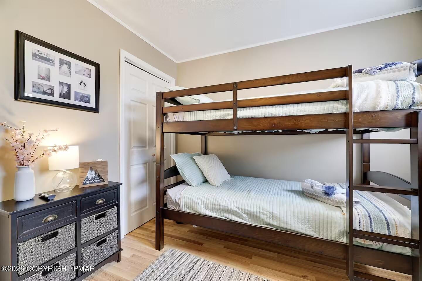 242 St Andrews Drive Bushkill, PA 18324 - Photo 24 of 36 a bedroom with a bed and wooden floor