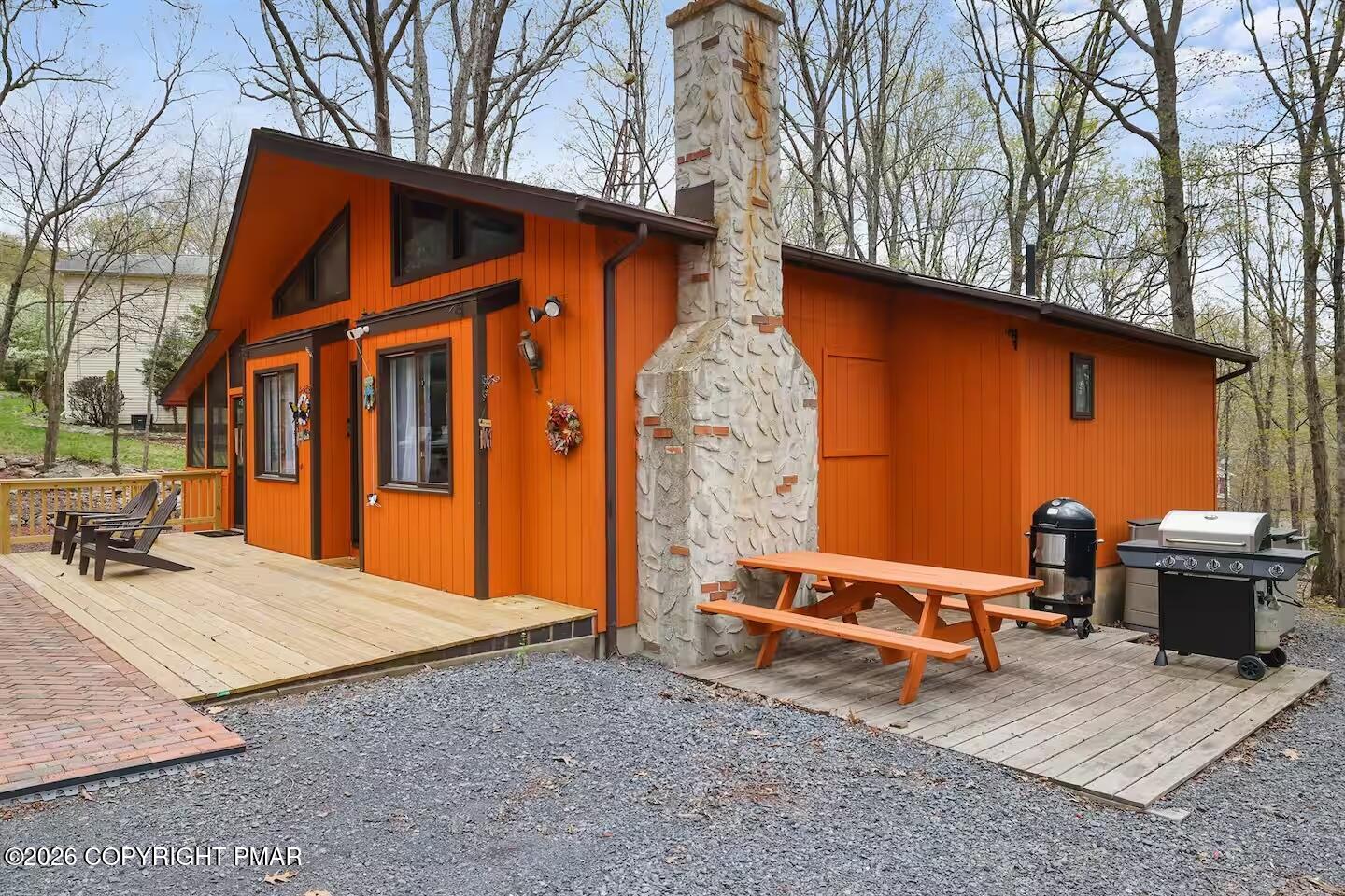 242 St Andrews Drive Bushkill, PA 18324 - Photo 3 of 36 a backyard of a house with sofas fire pit and outdoor seating