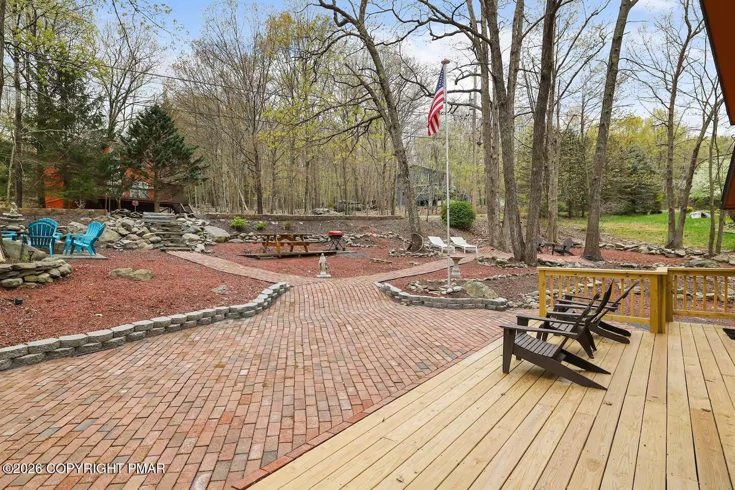 242 St Andrews Drive Bushkill, PA 18324 - Photo 5 of 36 a view of a wooden floor with chairs on a patio