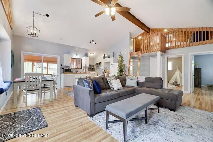 242 St Andrews Drive Bushkill, PA 18324 - Photo 9 of 36 a living room with furniture kitchen view and a chandelier