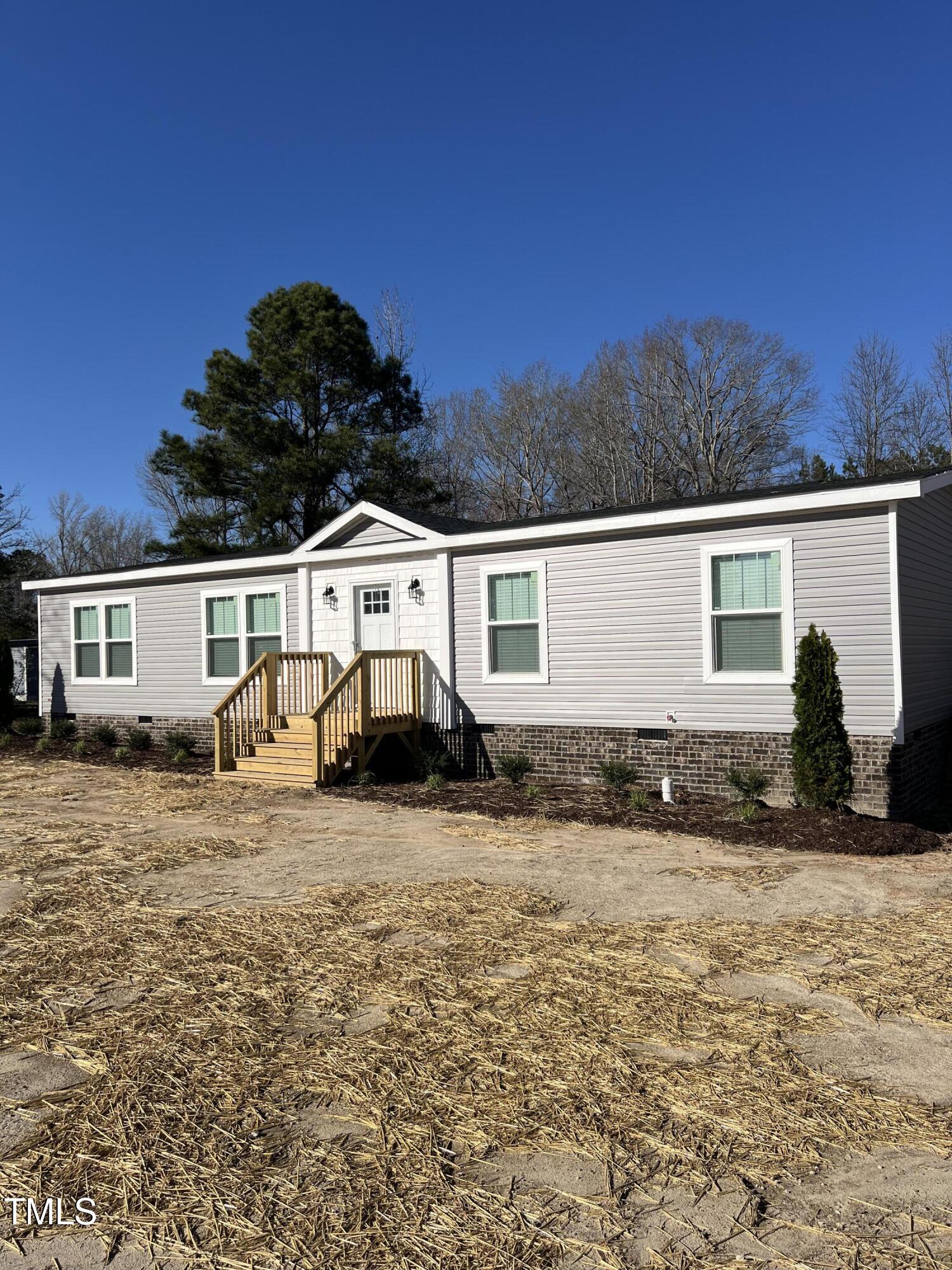 321 Duke Memorial Road Louisburg, NC 27549 - Photo 3 of 16 a view of a house with a yard