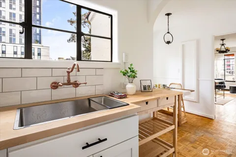 a view of a kitchen with a large window and sink