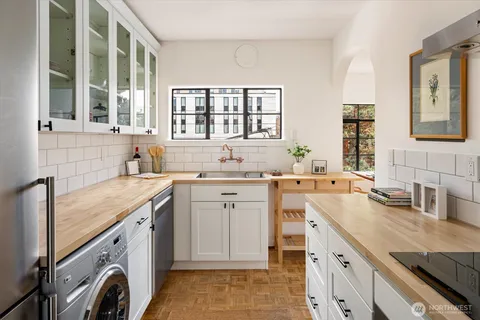 a view of a sink and washer dryer