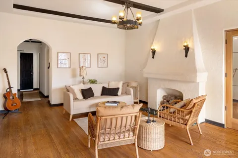 a living room with furniture and a chandelier