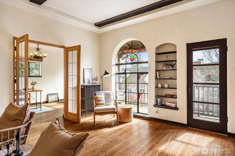 a living room with furniture and a floor to ceiling window