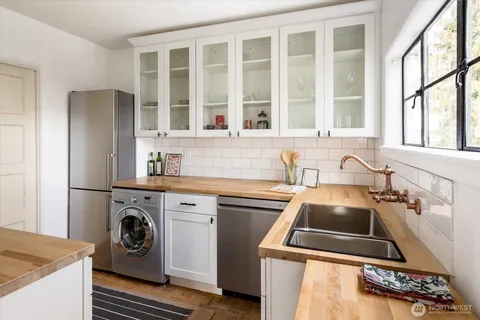 a kitchen that has a sink and a stove