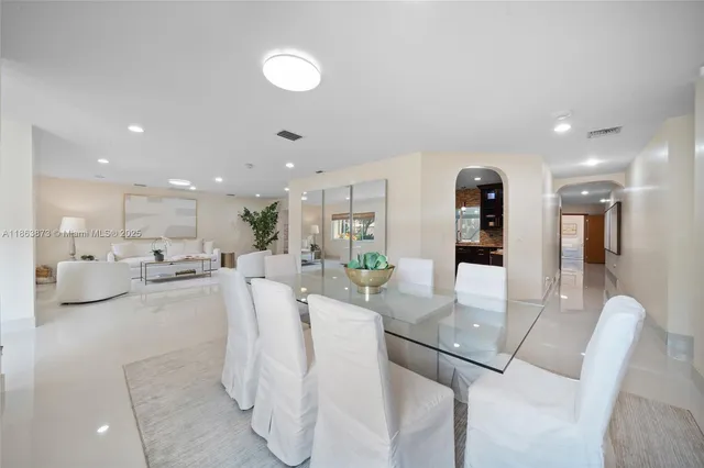 a living room with furniture and a view of kitchen