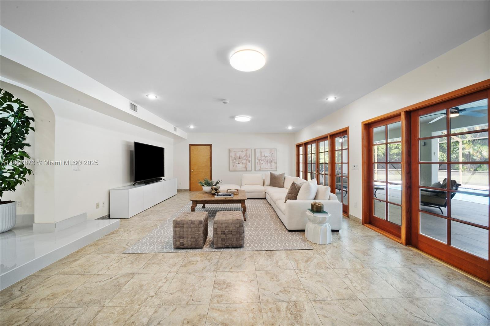 6125 Southwest 109th Street Pinecrest, FL 33156 - Photo 16 of 40 a living room with furniture and a flat screen tv