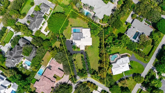 an aerial view of a house with a yard and garden