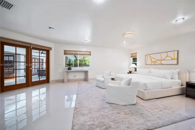 a spacious bedroom with a large bed and a couch