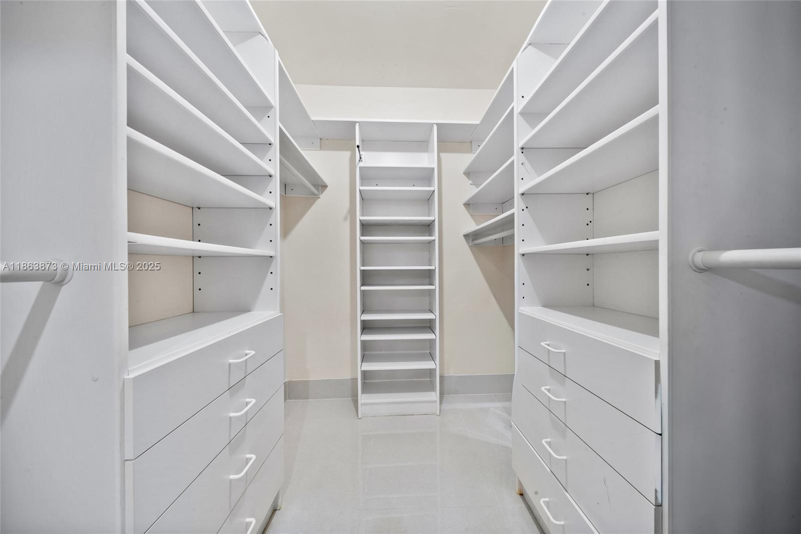 6125 Southwest 109th Street Pinecrest, FL 33156 - Photo 26 of 40 a view of walk in closet with empty racks