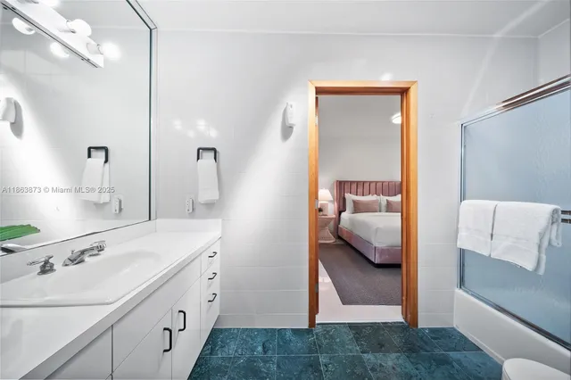 a en suite bathroom with a sink and mirror